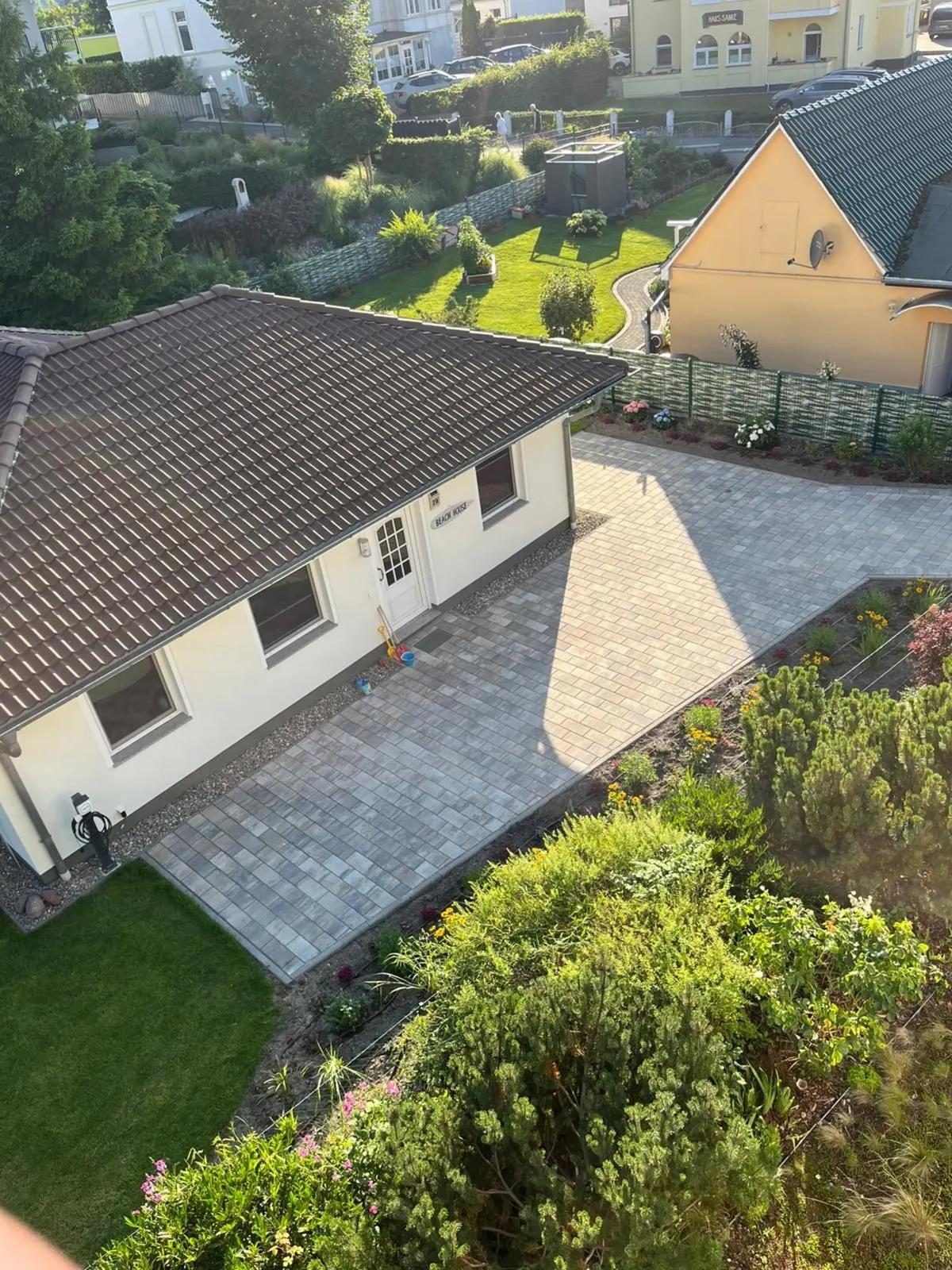 Aerial view of the Strandnest holiday home with plot and neighbourhood